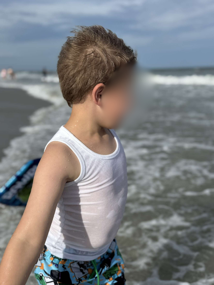 Boy at water’s edge
