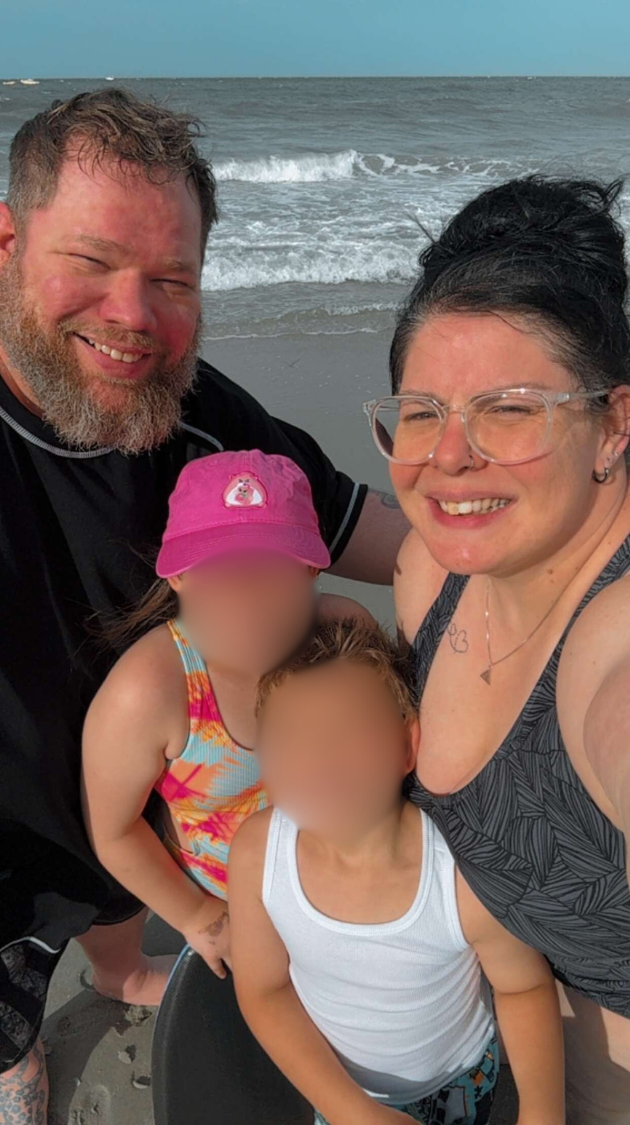 Family smiling on beach