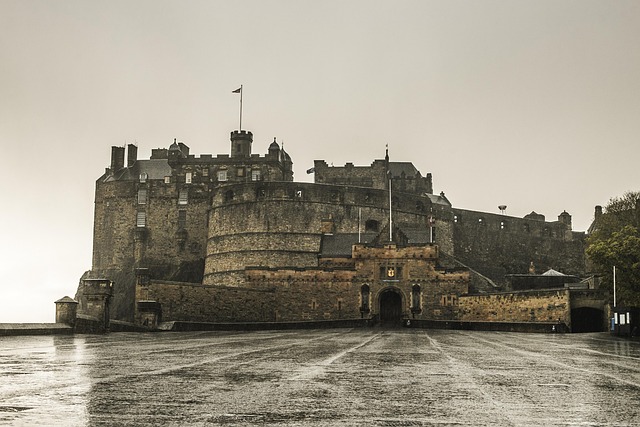 Edinburgh Castle on a hill under a cloudy sky.
