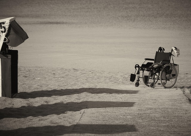 A wheelchair on an accessible beach path leading to the ocean in Hawaii.
