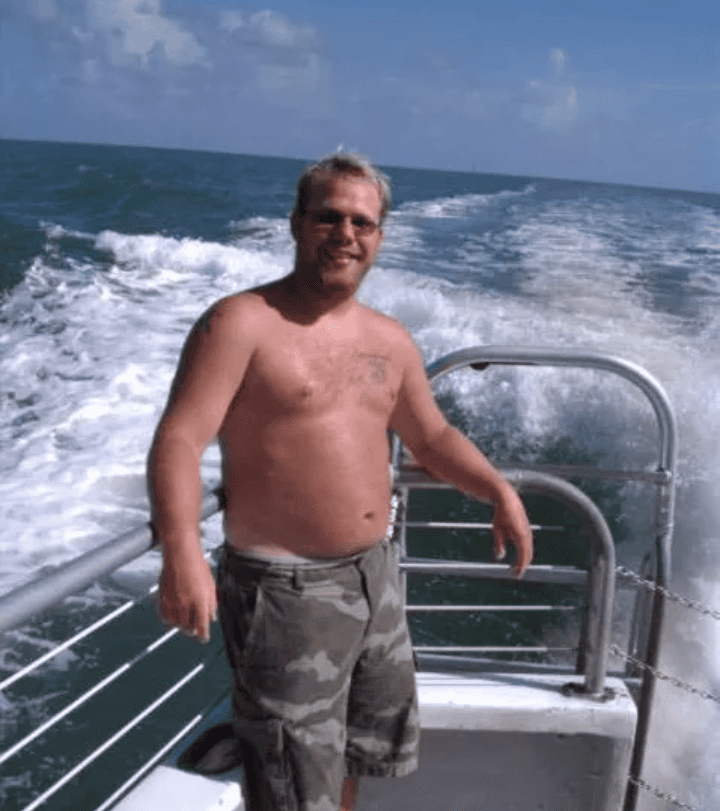Brett smiling on a dive boat